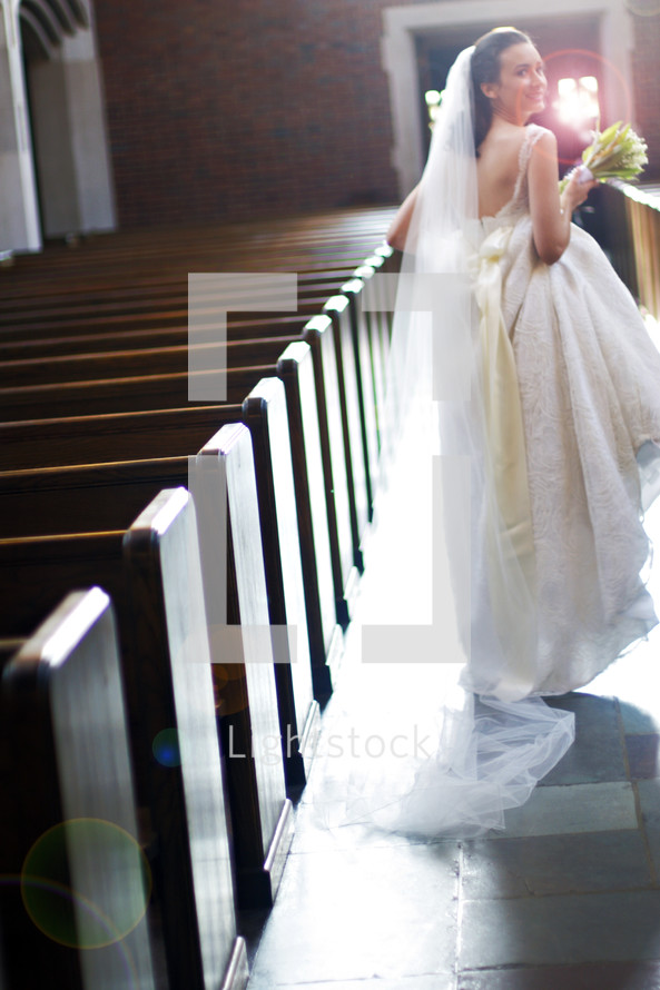 bride walking down the aisle of an empty church
