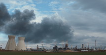 Timelapse of accident in oil refinery - huge explosions and fireballs rising while thick black smoke covers the sky.