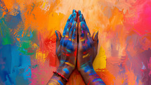 Vibrant painted hands folder i prayer. Asian influences, playful creativity. 