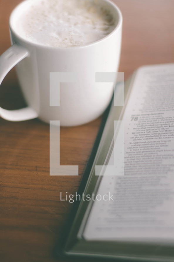 coffee cup and an open Bible