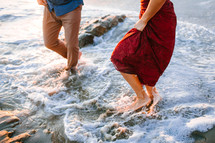 couple running into the ocean 