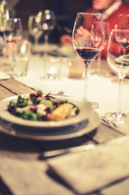 salad and wine glasses at a dinner party 