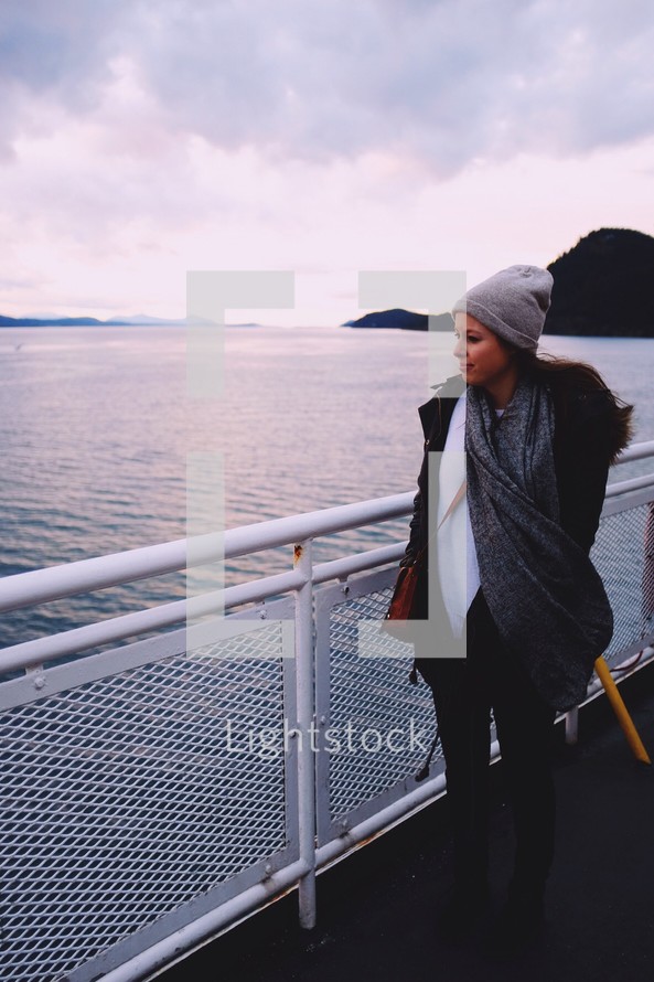 a woman standing on a ferry 