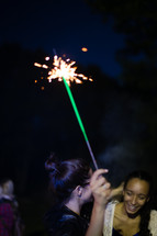 teen girl holding a sparkler 