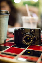 Camera on a cafe table.