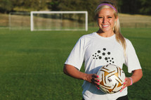 teen girl holding a soccer ball 