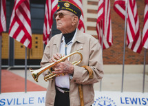 A Veteran playing a trumpet to honor fallen soldiers