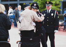 A Veteran hugging a police officer 