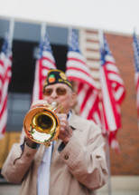 Veteran playing a trumpet to honor fallen soldiers 
