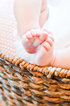 newborn feet in a bassinet 