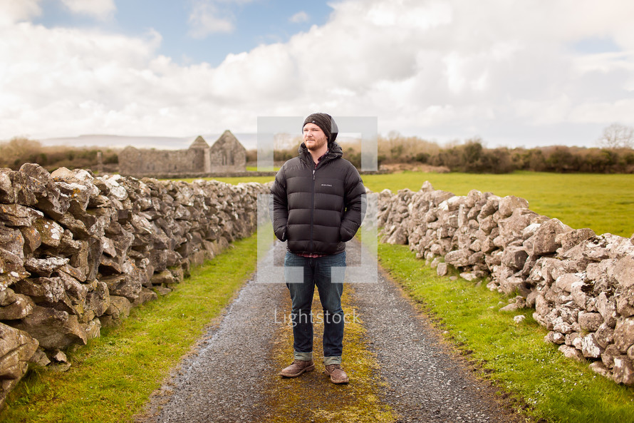 man standing on a gravel road in Scotland