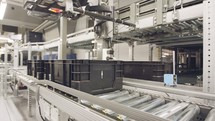 Large Boxes moving on conveyors in a large automated warehouse