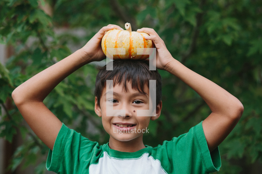 boy with a pumpkin on his head