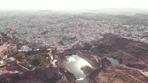 Wide view of Ranisar Padamsar Lakes and Mehrangarh Fort beside them in Jodhpur, Rajasthan, India - Aerial panoramic Reveal shot 