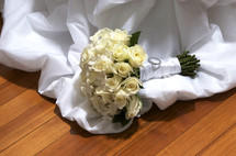 bouquet of white roses on a bridal gown 