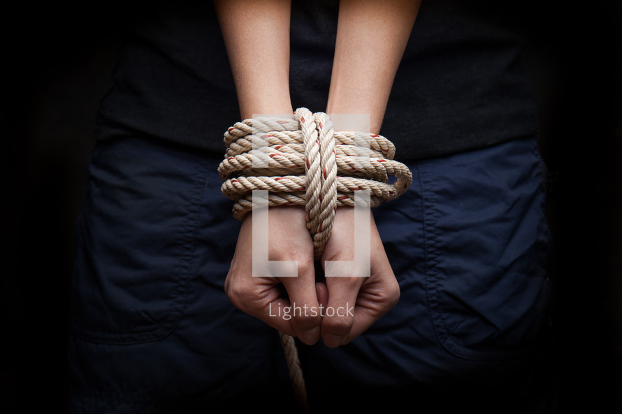 wrists bound in rope 