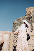Women walking up the steps of the Muttrah Fort in Muscat, Oman