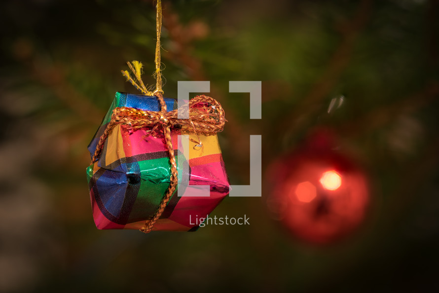 a handmade ornament hanging on a Christmas tree 