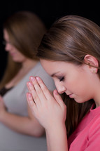 Teen girls with praying hands 