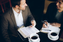 two men smiling and talking over coffee at a Bible study
