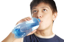 a boy drinking bottled water 