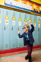 kid standing in front of lockers 