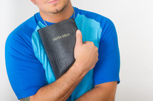 man holding a Santa Biblica 