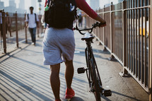 man with a bicycle crossing the Brooklyn Bridge 