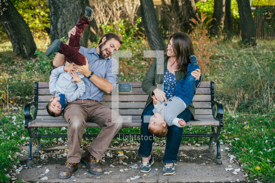 playful family sitting on a bench 