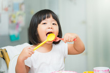 a toddler girl eating 