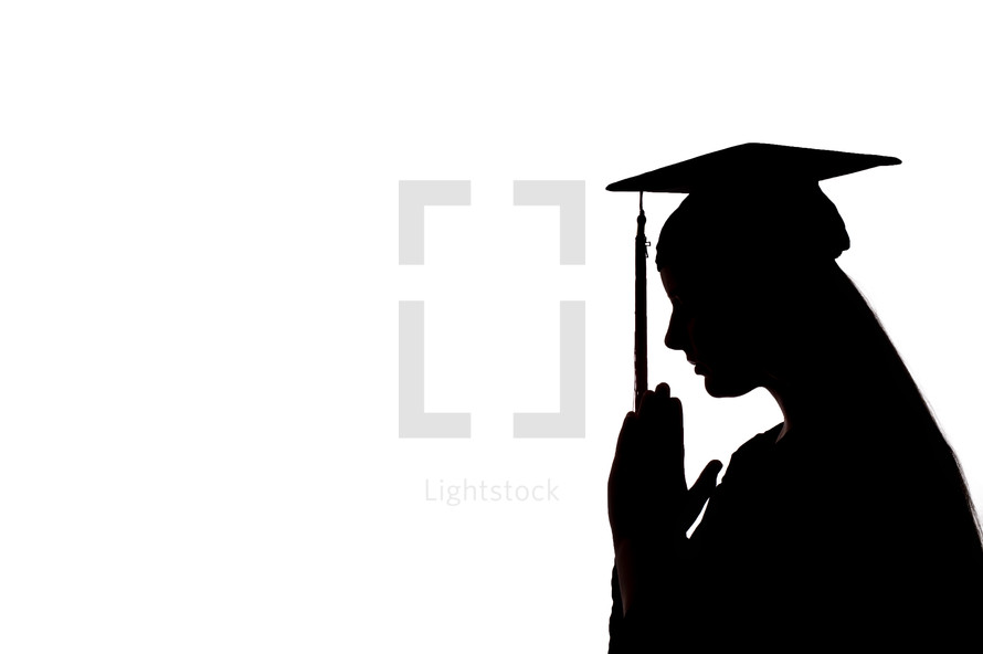 silhouette of a graduate with praying hands 