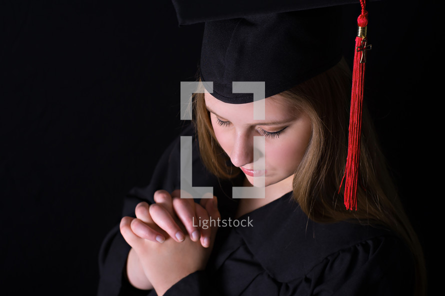 graduate with praying hands 