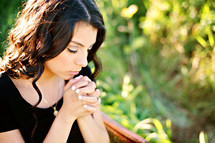 Latino woman with praying hands 