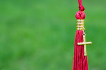 red tassel and cross