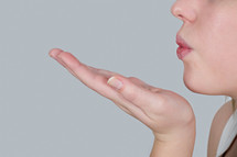 woman blowing a kiss