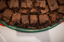 A pile of brownies on a plate.