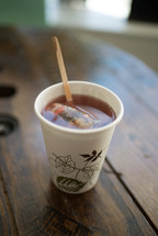 coffee stirrer in a paper coffee cup 