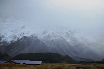 clouds over snowy mountain peaks in New Zealand  