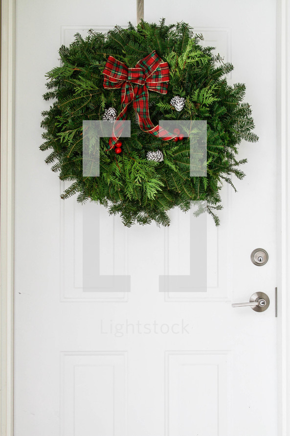 Christmas wreath hanging on a door 