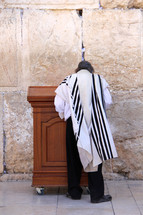 Jewish man worshipping at the Western Wall in Jerusalem.