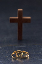 Set of gold wedding rings and cross 