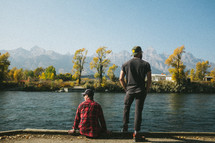 men looking out at a lake 