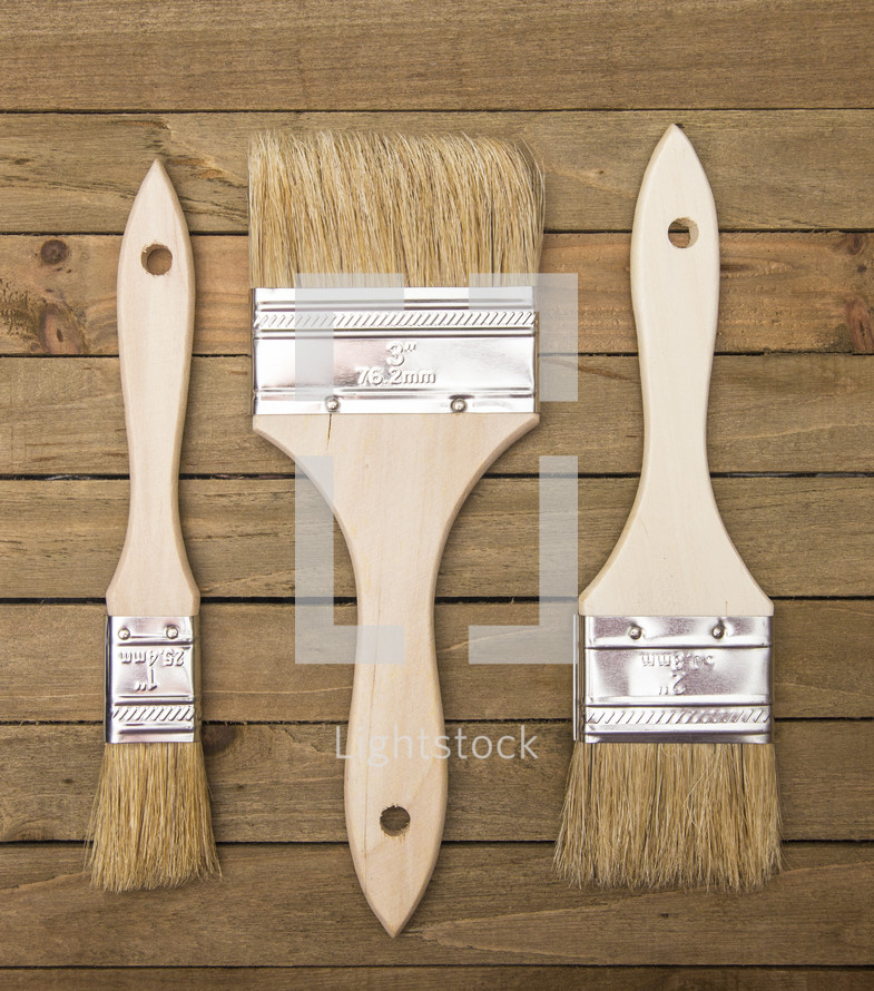 paint brushes on wood background 