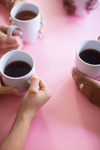 women holding coffee mugs 