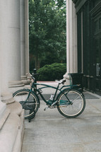 bicycle parked near columns 