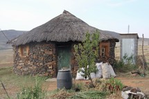 village hut with outhouse 