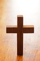 small wood cross on a wood table 