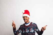 man in an ugly Christmas sweater and santa hat 