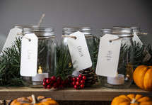 Tealights in jars for advent with pumpkins and Christmas decor