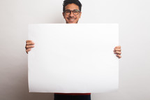 a man holding up a blank sign 